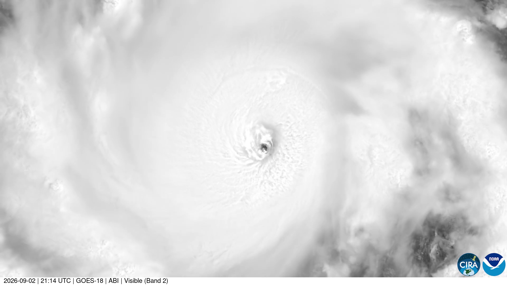 Greyscale GOES-18 visible satellite frame of Hurricane Lowell at 21:14 UTC on Sep 2, 2026: a small, clear eye at the center of a vast, smooth shield of bright cloud, with a time stamp bar and CIRA and NOAA logos along the bottom.