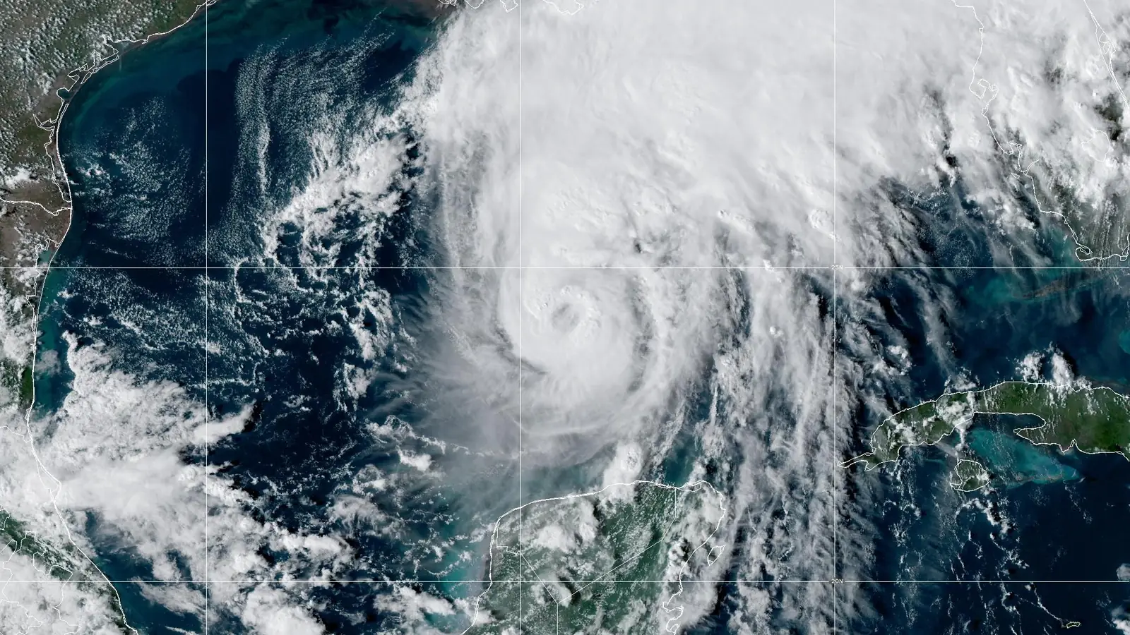 GOES-19 GeoColor satellite image of Hurricane Isaias at 5 PM EDT Oct 8, 2026: a small eye in a dense, round core over the southern Gulf of Mexico, with a broad cloud shield spreading northeast over the Florida Panhandle.