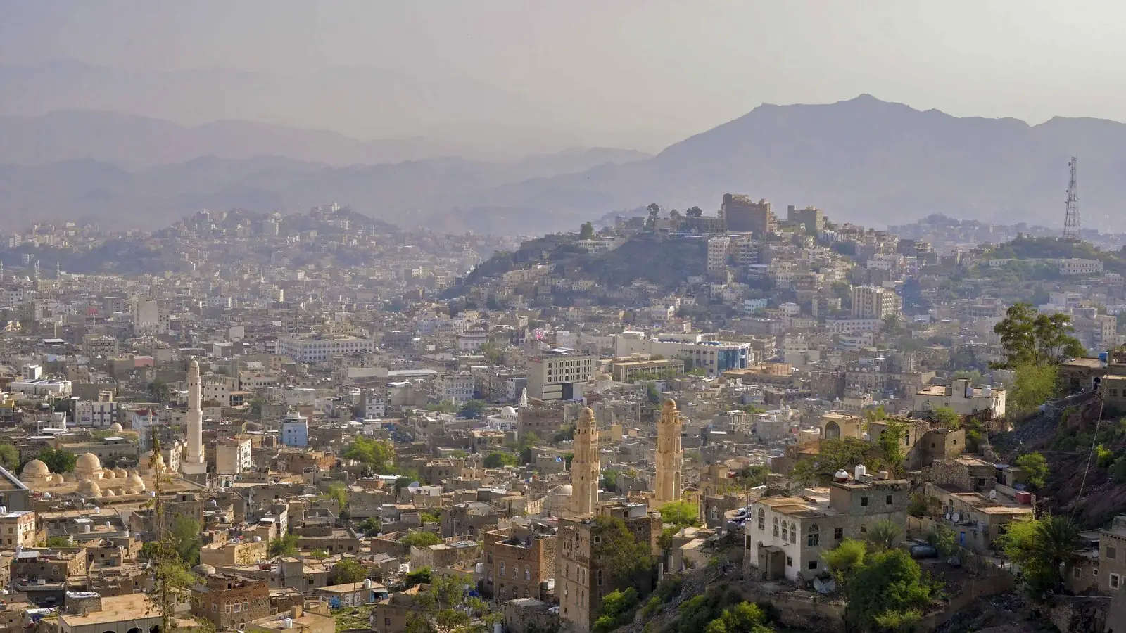 File photo from August 2013: the city of Taiz, Yemen, seen from a hillside, with dense low-rise buildings, minarets and hazy mountains behind. Taiz is one of the fronts the Saudi-led coalition named on Oct 4.