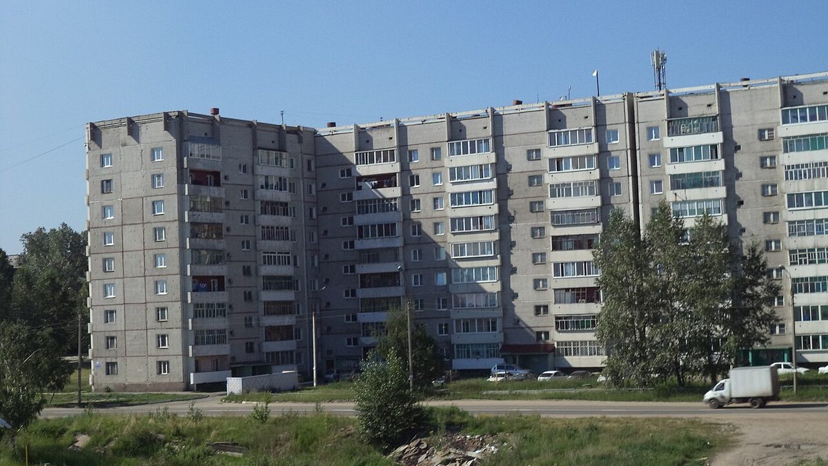 Nine-story apartment blocks on Beloborodova Street in Shelekhov, Irkutsk region, under a clear sky — file photo from 2013